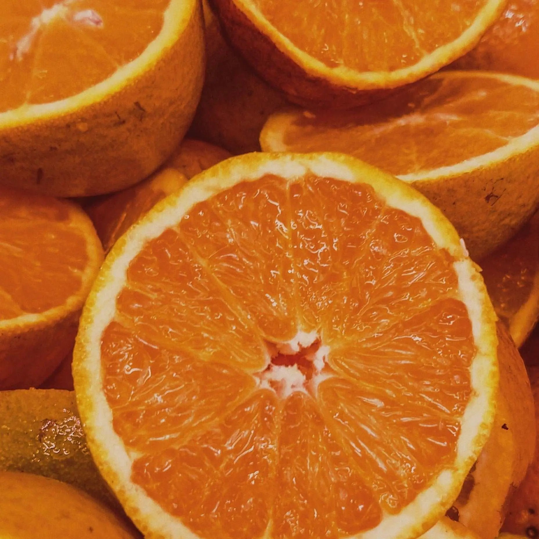 a blood orange cut in half sitting on a table 